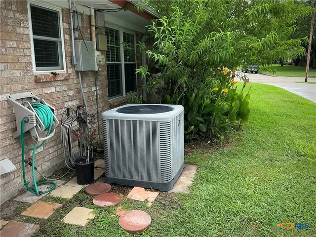 a view of a backyard with table and chairs and potted plants
