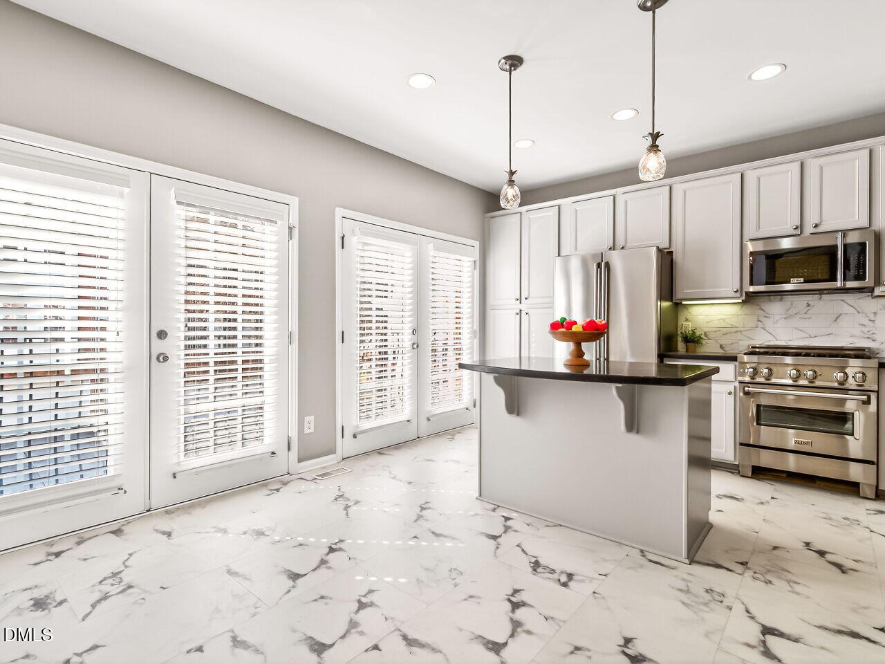 2512 Blooming Street Raleigh, NC 27612 - Photo 13 of 33 a kitchen with stainless steel appliances granite countertop a stove a sink and a refrigerator