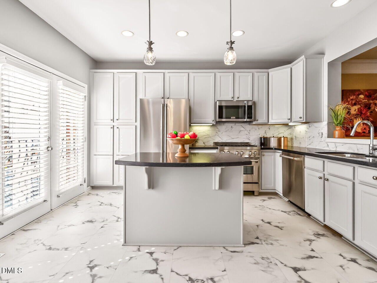 2512 Blooming Street Raleigh, NC 27612 - Photo 14 of 33 a kitchen with stainless steel appliances granite countertop a stove top oven a sink dishwasher a refrigerator and white cabinets with wooden floor