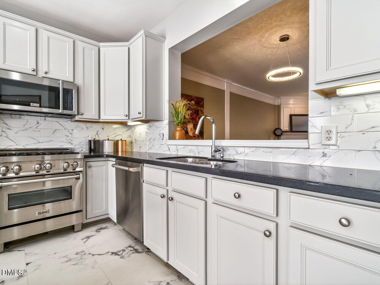 2512 Blooming Street Raleigh, NC 27612 - Photo 17 of 33 a kitchen with stainless steel appliances granite countertop a sink and a stove