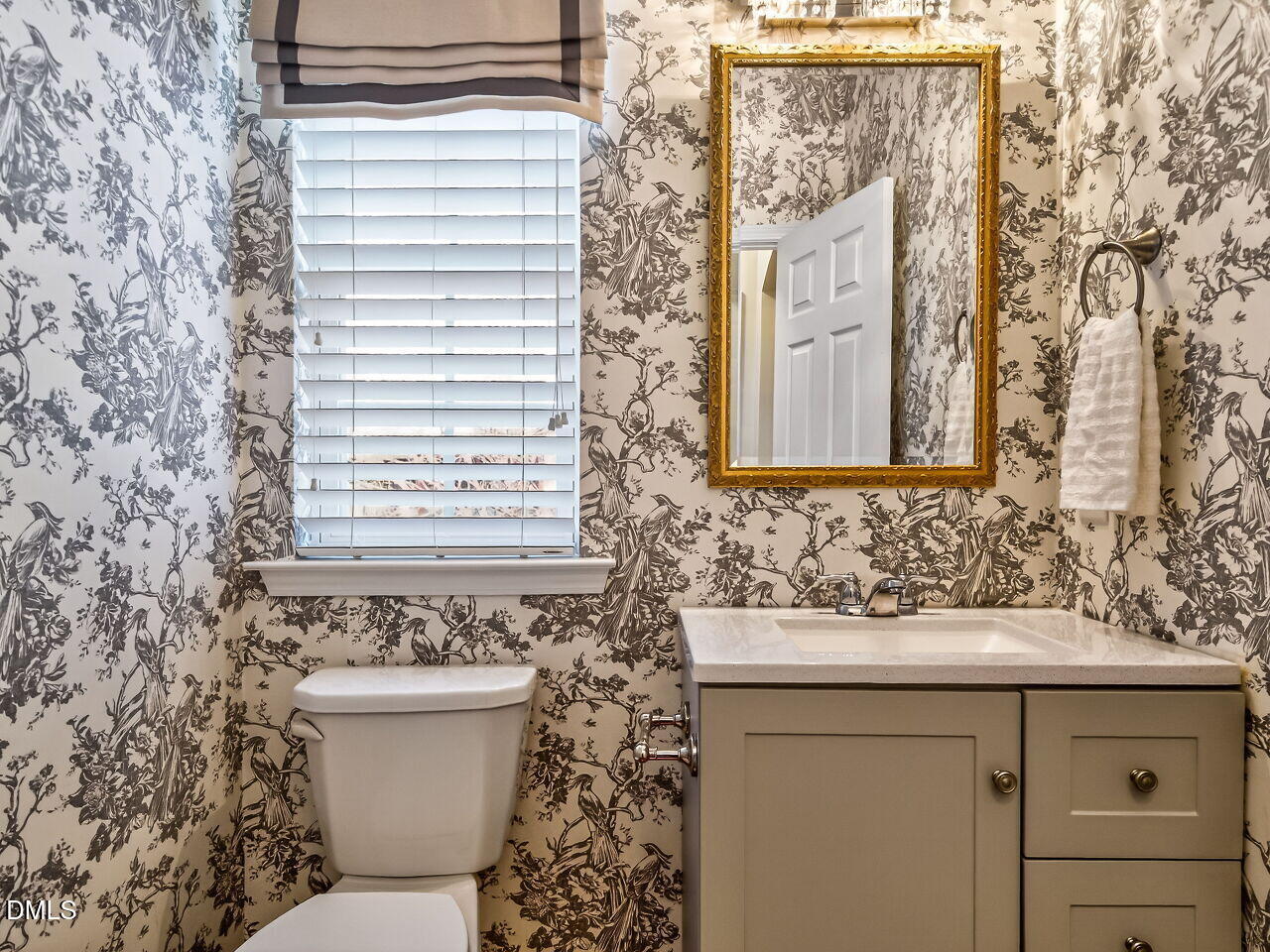 2512 Blooming Street Raleigh, NC 27612 - Photo 18 of 33 a bathroom with a toilet sink and mirror