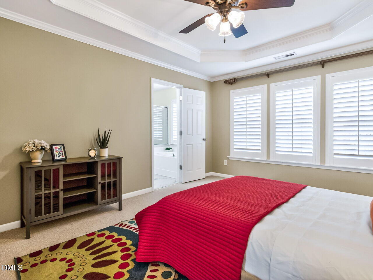 2512 Blooming Street Raleigh, NC 27612 - Photo 23 of 33 a bedroom with a bed and a chandelier
