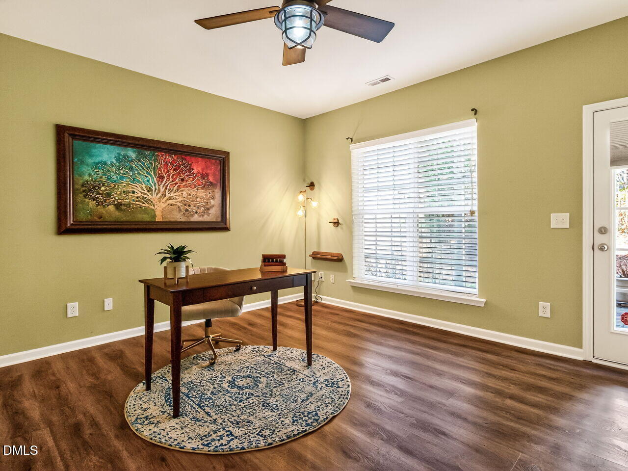 2512 Blooming Street Raleigh, NC 27612 - Photo 29 of 33 a dining room with wooden floor a chandelier a wooden table and chairs