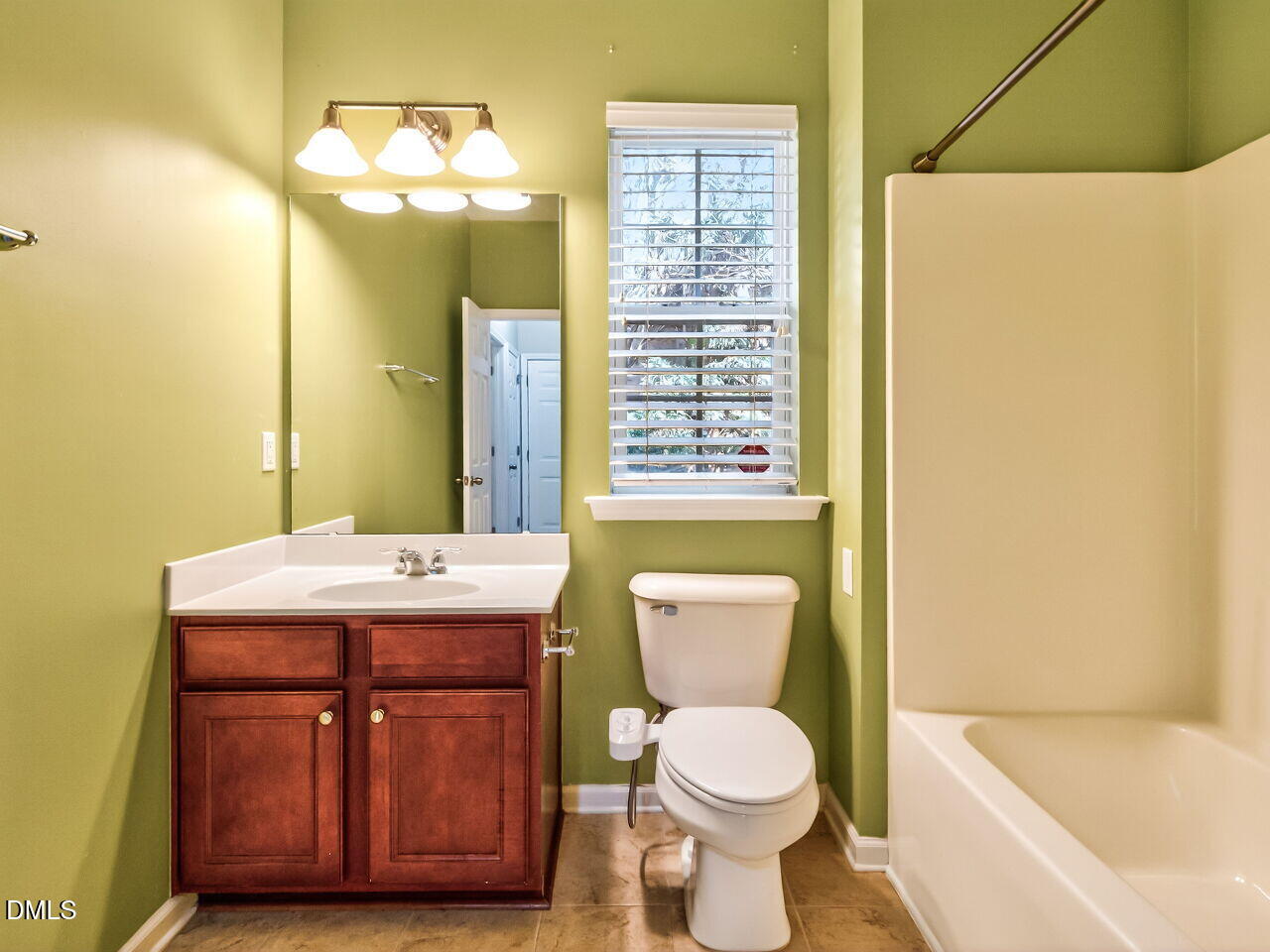 2512 Blooming Street Raleigh, NC 27612 - Photo 31 of 33 a bathroom with a sink a toilet and bathtub
