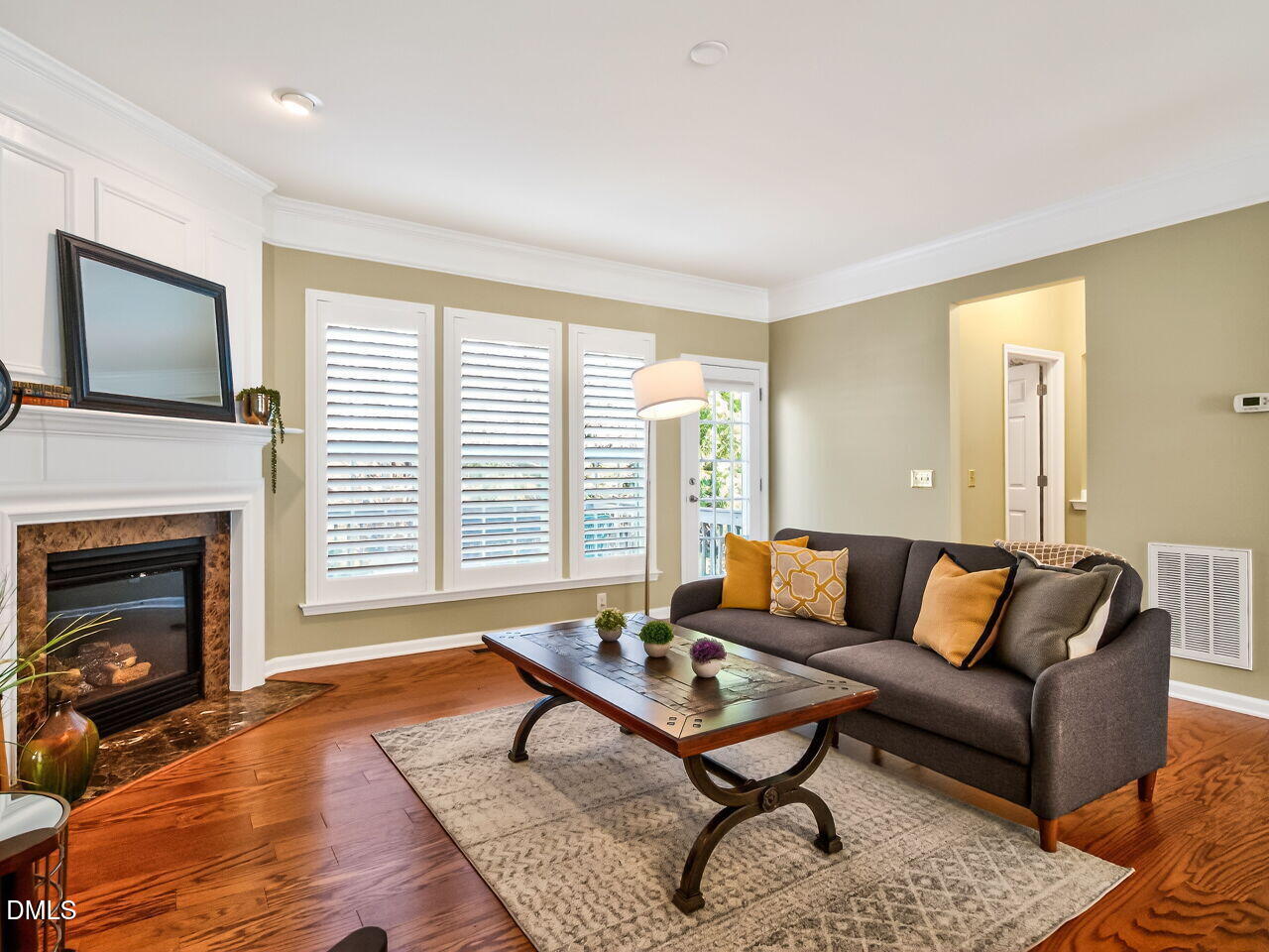 2512 Blooming Street Raleigh, NC 27612 - Photo 7 of 33 a living room with furniture a flat screen tv and a fireplace