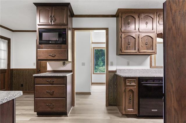 a kitchen with a stove oven and cabinets
