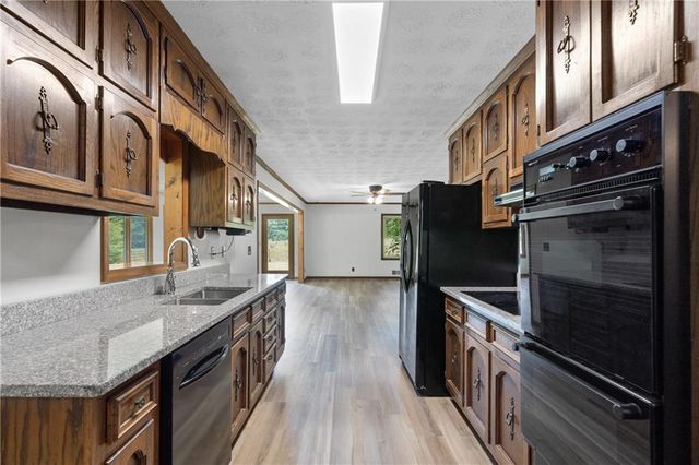 a kitchen with stainless steel appliances granite countertop a sink and stove