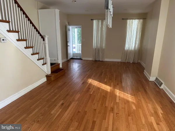 wooden floor in an empty room with windows