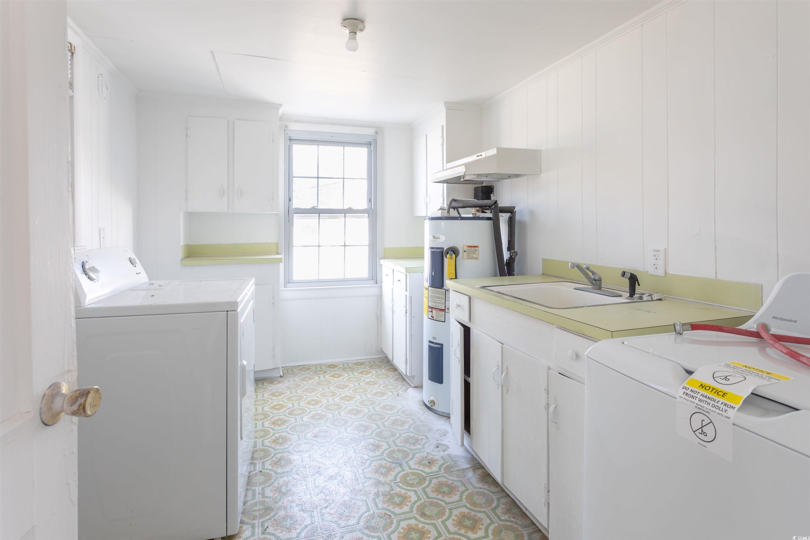 214 Yucca Avenue Murrells Inlet, SC 29576 - Photo 22 of 22 Kitchen with white cabinets, light countertops, water heater, washer and dryer, and light flooring