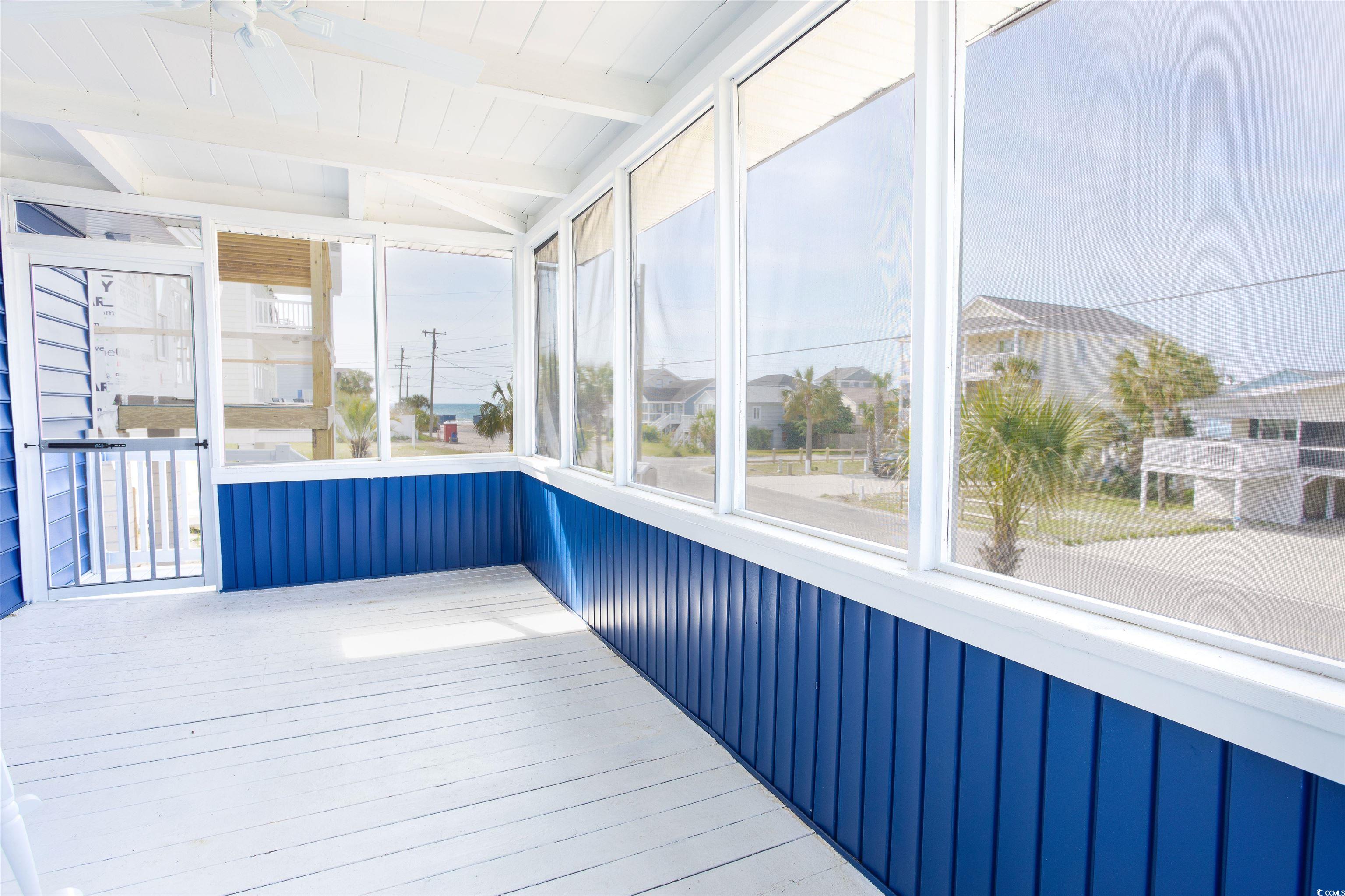 214 Yucca Avenue Murrells Inlet, SC 29576 - Photo 7 of 22 Unfurnished sunroom with beam ceiling and a residential view