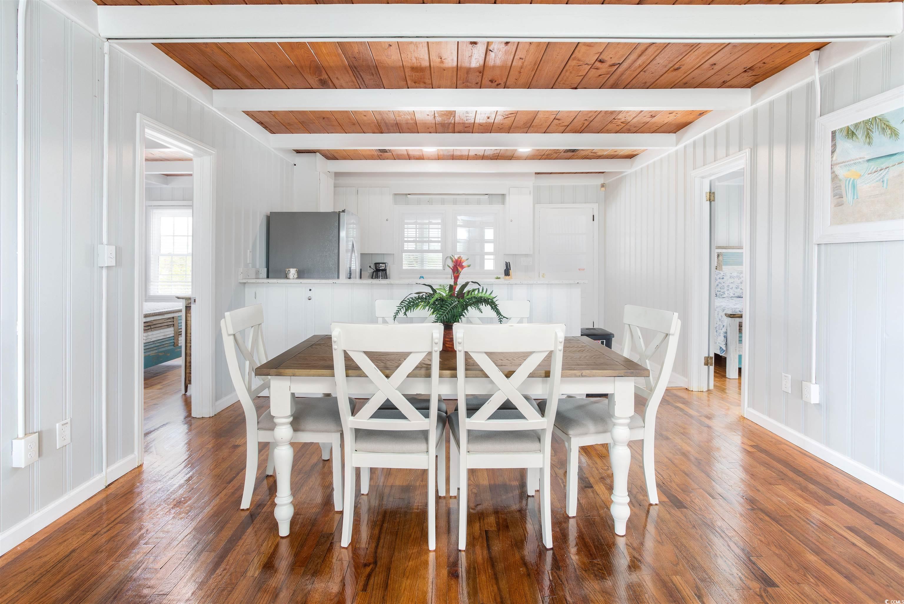 214 Yucca Avenue Murrells Inlet, SC 29576 - Photo 10 of 22 Dining area featuring plenty of natural light, dark wood-type flooring, and a wooden ceiling with exposed beams