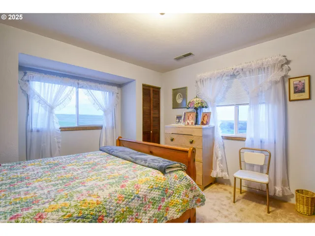 a bedroom with a bed a table and chair