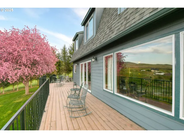 a balcony with wooden floor and outdoor space