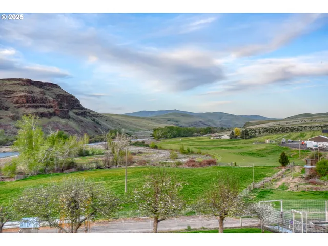 a view of grassy field with mountain