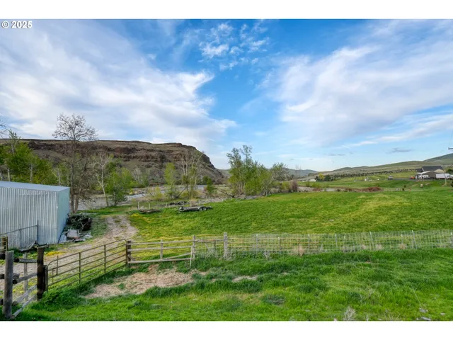 a view of a field with sitting area