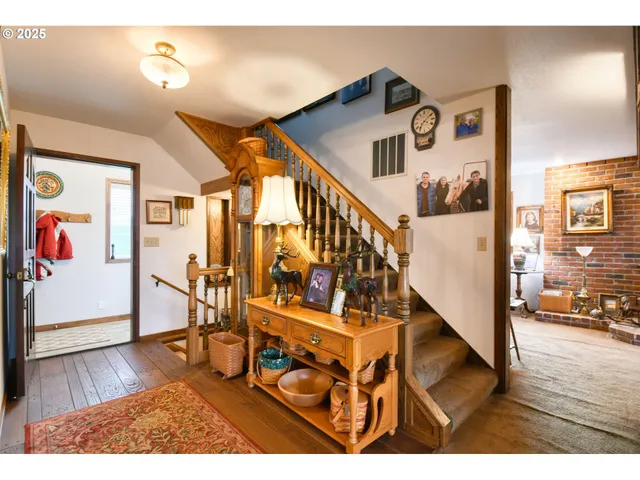 a view of entryway and hall with wooden floor