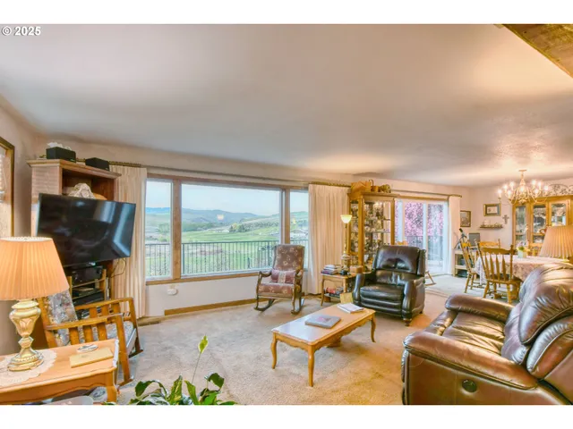 a living room with furniture and a floor to ceiling window