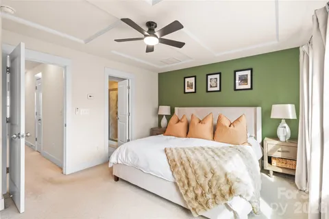 a bedroom with a large bed and a chandelier
