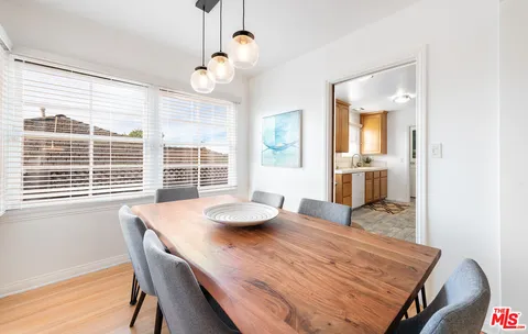 a dining room with wooden floor and breakfast area