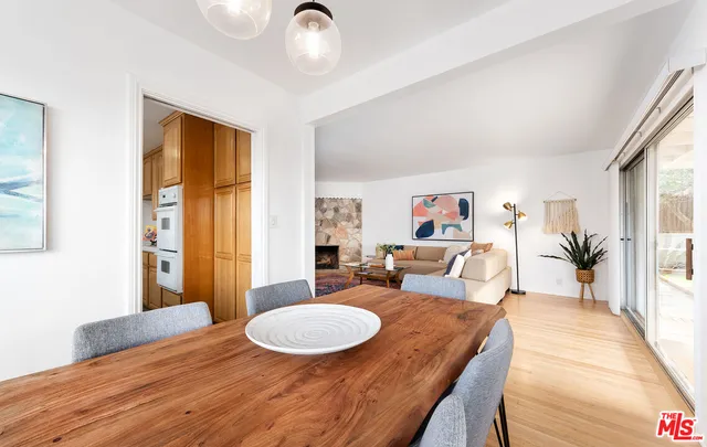 a living room with furniture a wooden floor and next to a window