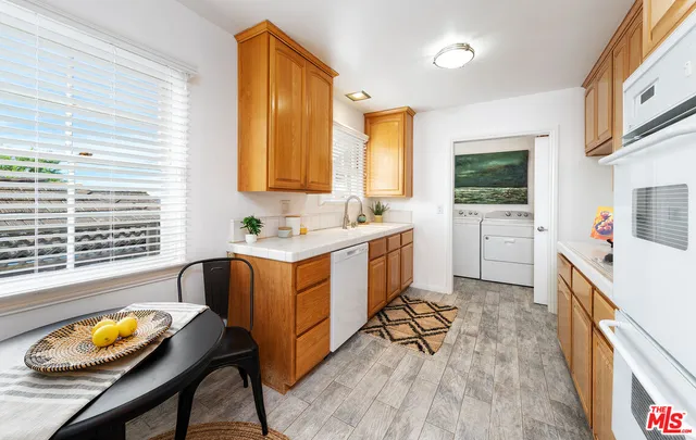 a kitchen with a sink appliances and cabinets