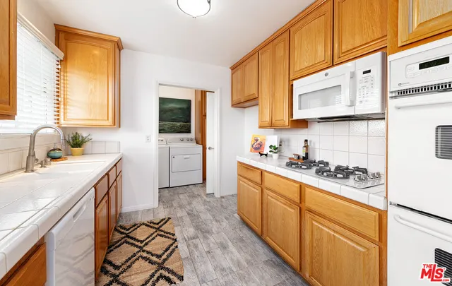 a kitchen with a stove a sink and a refrigerator
