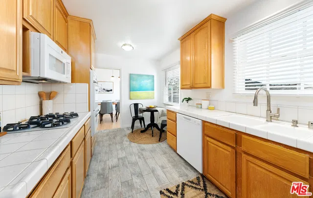 a kitchen with a sink a stove and cabinets