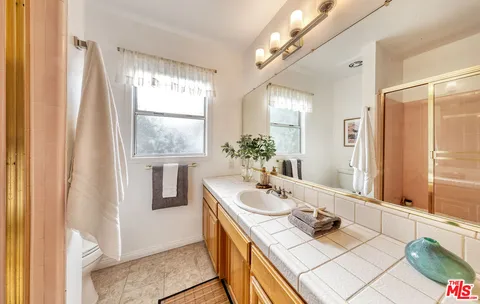 a dining room with wooden floor and large windows
