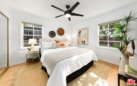 a bedroom with a bed next to a window with outer view