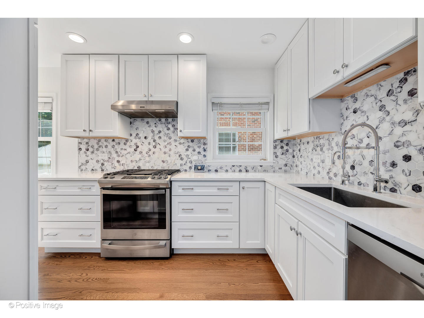 4101 Linden Avenue Western Springs, IL 60558 - Photo 8 of 29 a kitchen with stainless steel appliances white cabinets and a stove top oven