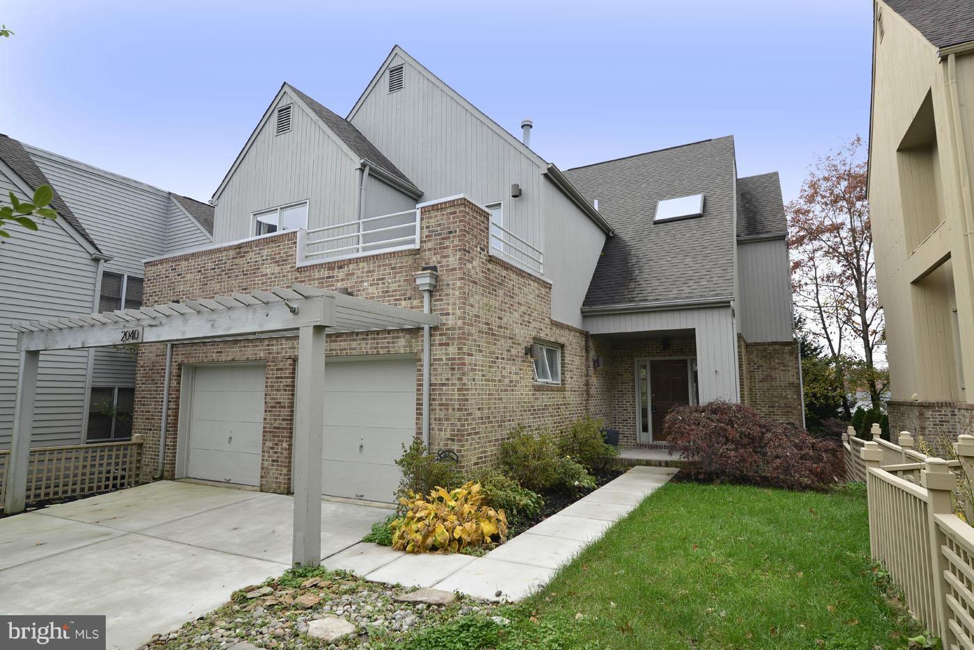 2040 Beacon Place Reston, VA 20191 - Photo 1 of 30 a front view of a house with a garden and plants