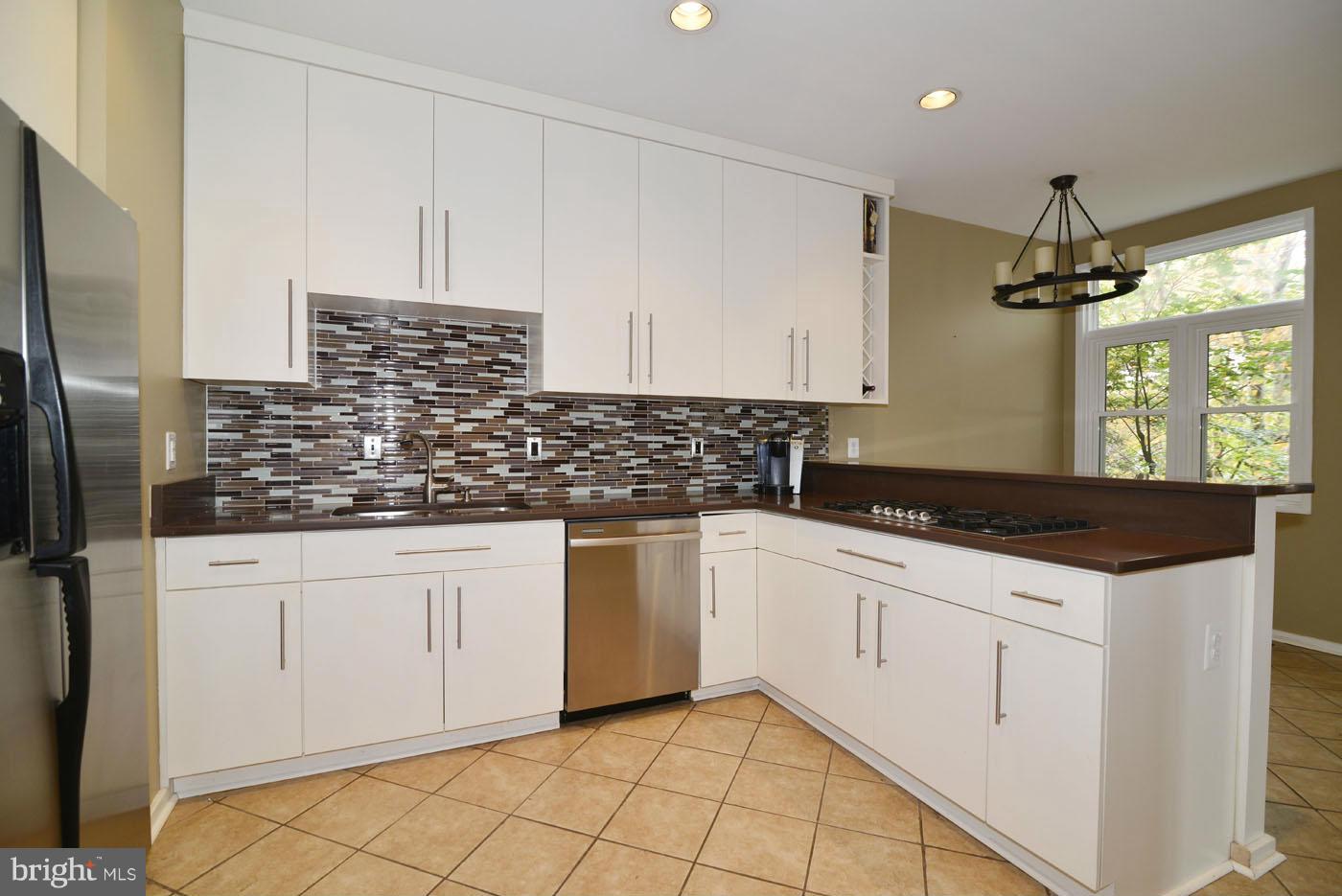 2040 Beacon Place Reston, VA 20191 - Photo 12 of 30 a kitchen with granite countertop white cabinets and white appliances