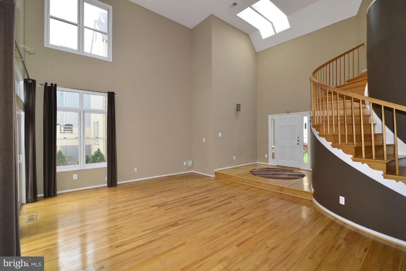 2040 Beacon Place Reston, VA 20191 - Photo 13 of 30 a view of an empty room with wooden floor and a window