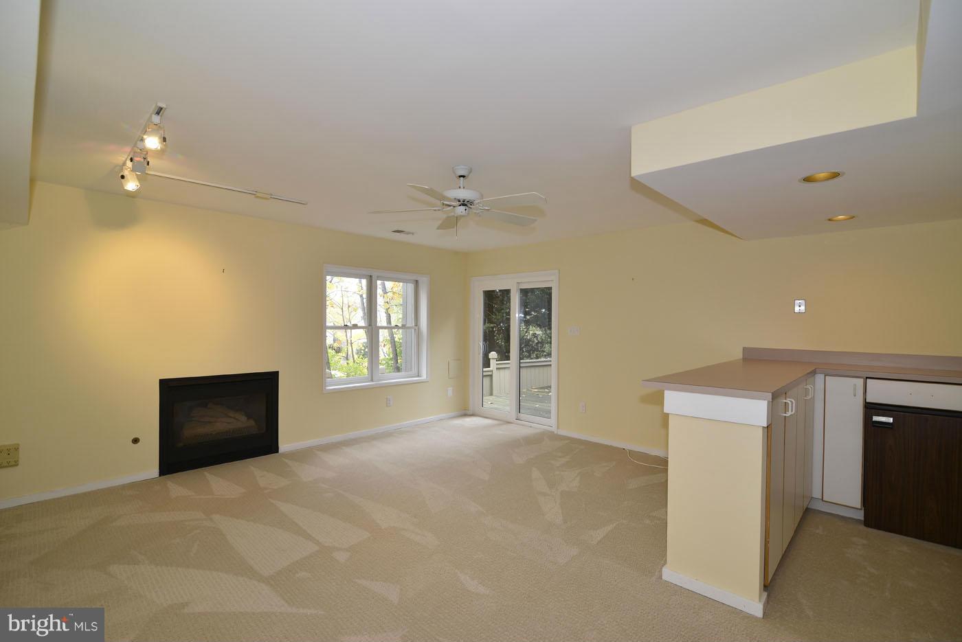2040 Beacon Place Reston, VA 20191 - Photo 21 of 30 a view of an empty room with a fireplace and a window