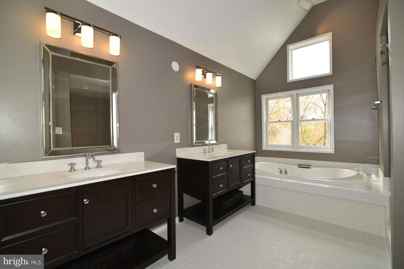 2040 Beacon Place Reston, VA 20191 - Photo 22 of 30 a spacious bathroom with a double vanity sink a toilet a mirror and a window