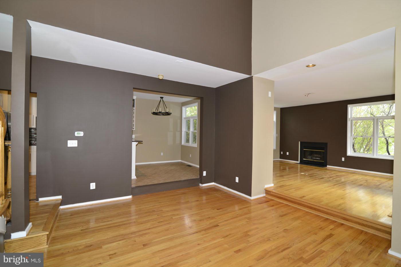 2040 Beacon Place Reston, VA 20191 - Photo 7 of 30 a view of a livingroom with wooden floor and a fireplace