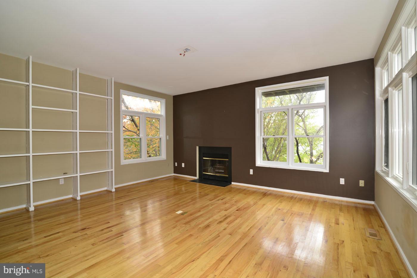 2040 Beacon Place Reston, VA 20191 - Photo 8 of 30 a view of an empty room with a window and wooden floor
