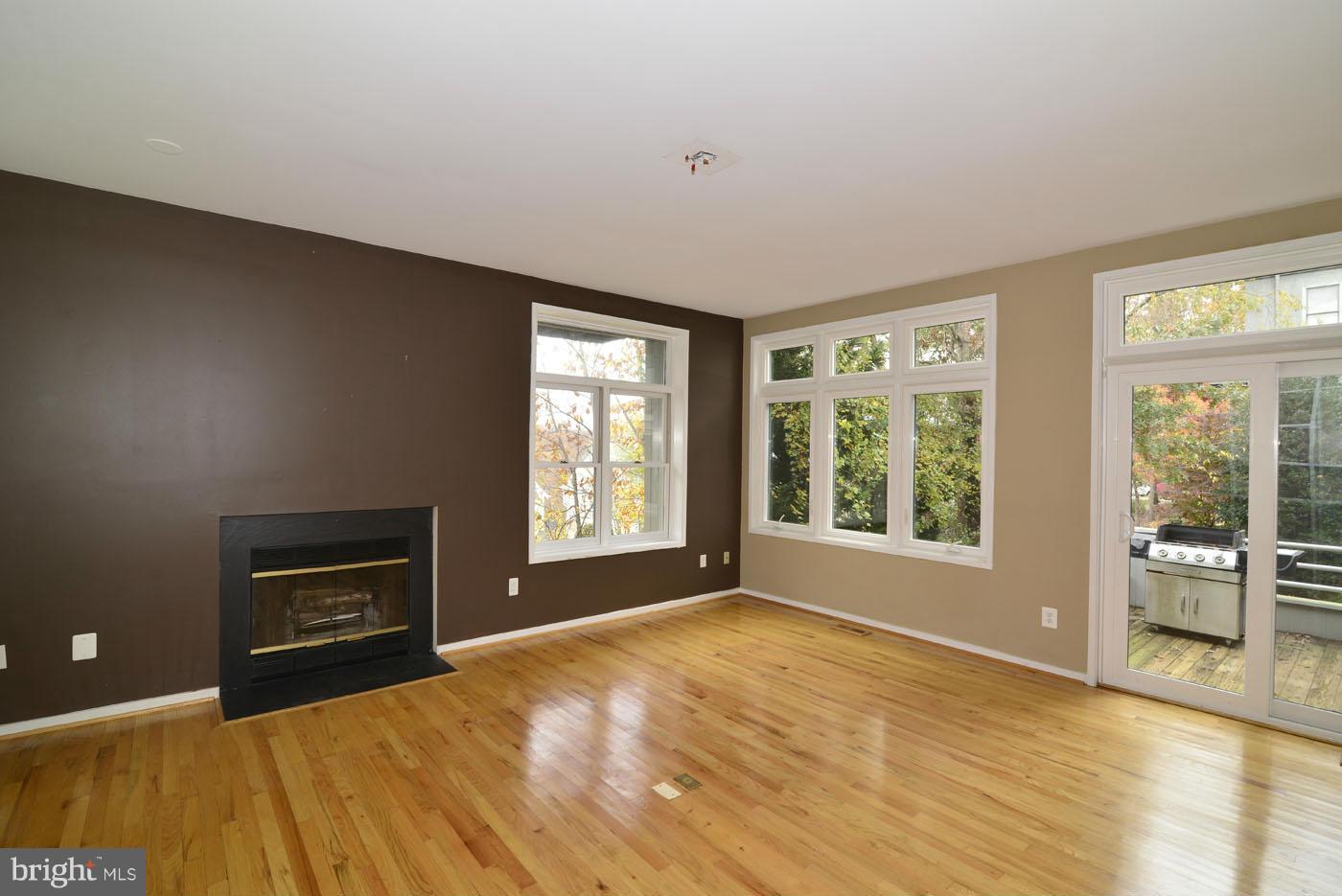 2040 Beacon Place Reston, VA 20191 - Photo 9 of 30 a view of an empty room with a window and wooden floor