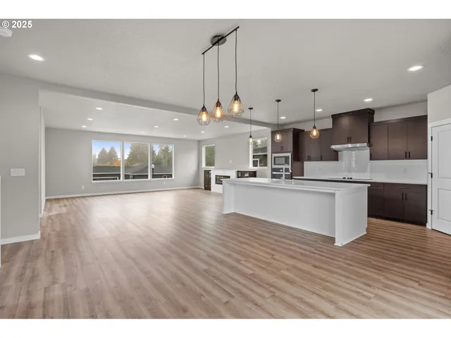 a view of kitchen with kitchen island microwave and refrigerator