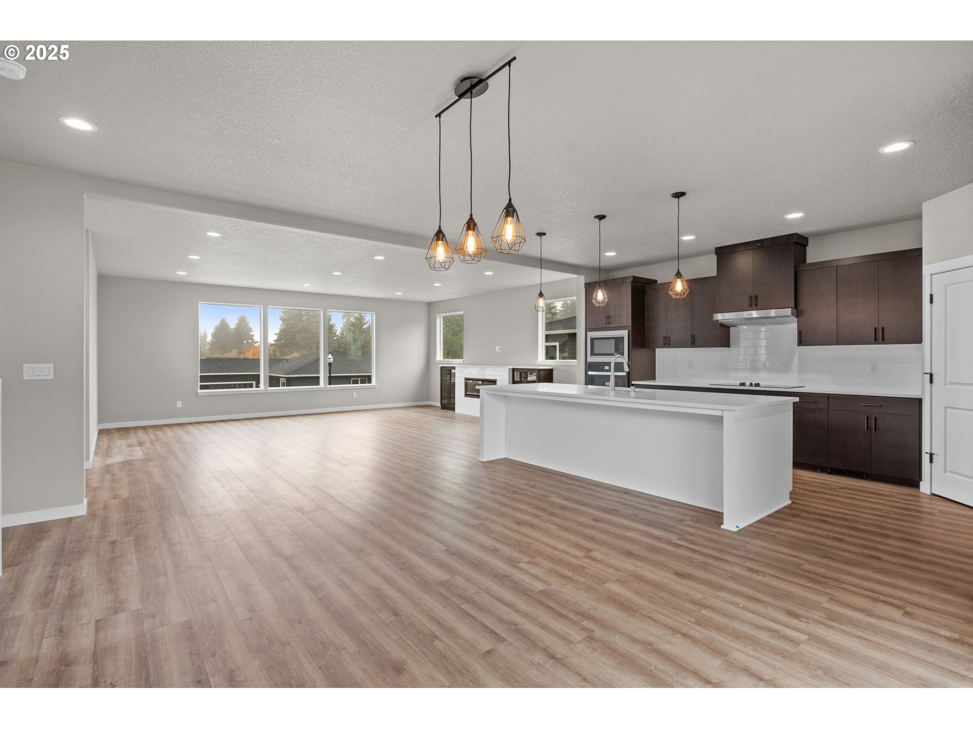 1105 Northwest 111th Circle Vancouver, WA 98685 - Photo 13 of 48 a large kitchen with stainless steel appliances kitchen island a large counter top and wooden floors