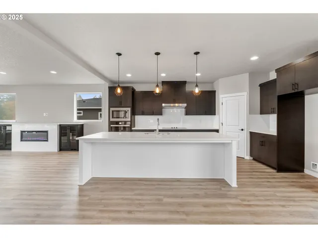 a living room with a sink and a microwave