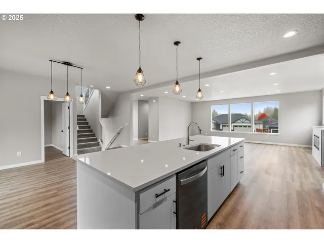 a view of kitchen with kitchen island a stove and wooden floor