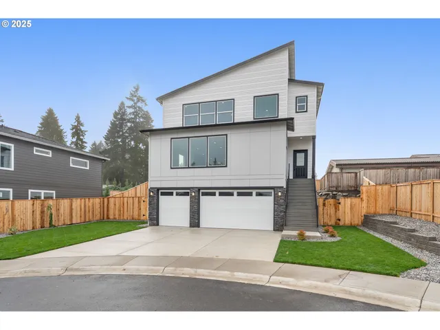 a front view of a house with a yard and a garage