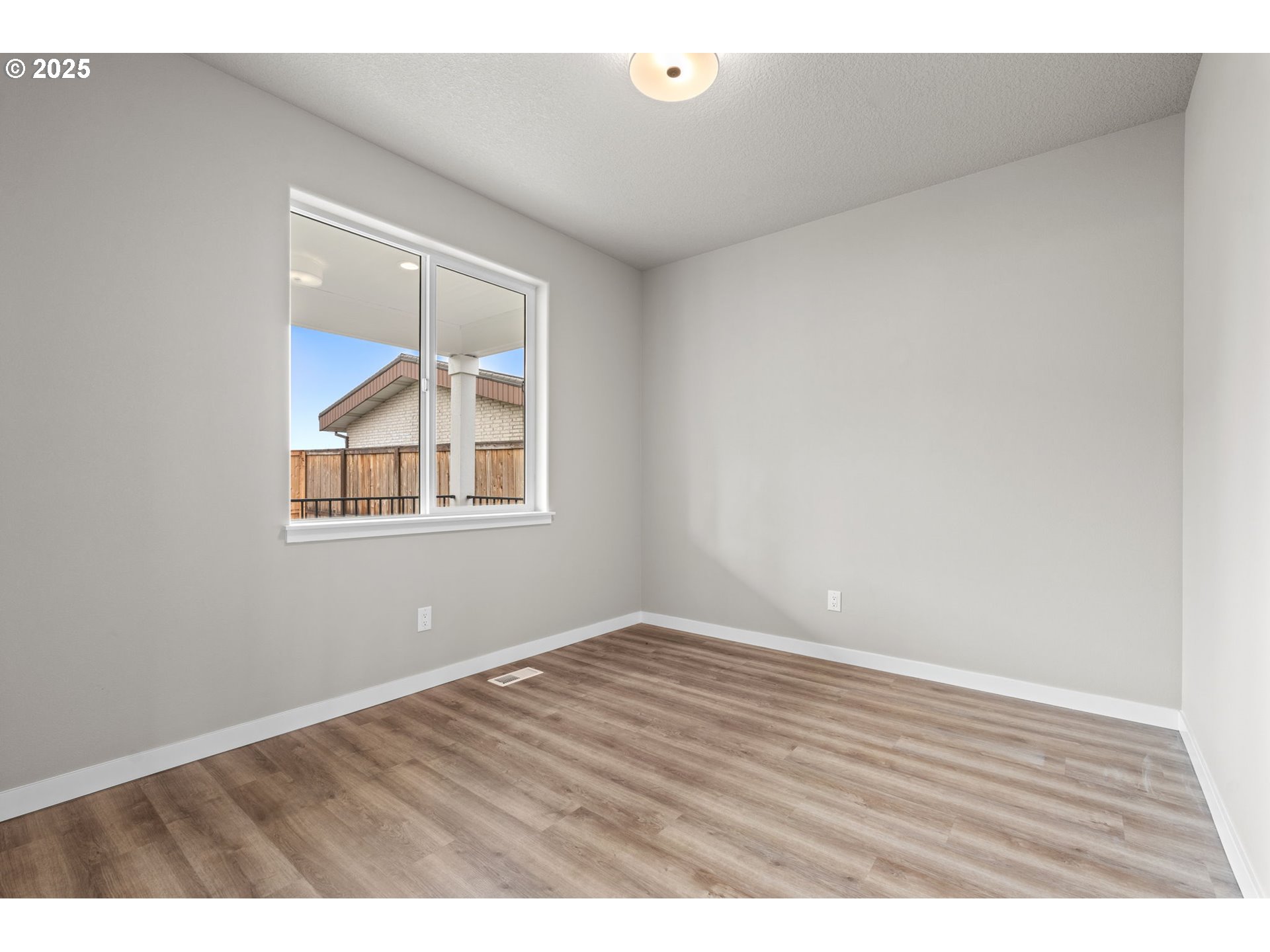 1105 Northwest 111th Circle Vancouver, WA 98685 - Photo 39 of 48 a view of an empty room with wooden floor and a window