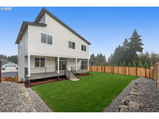 a view of a yard with a house in the background