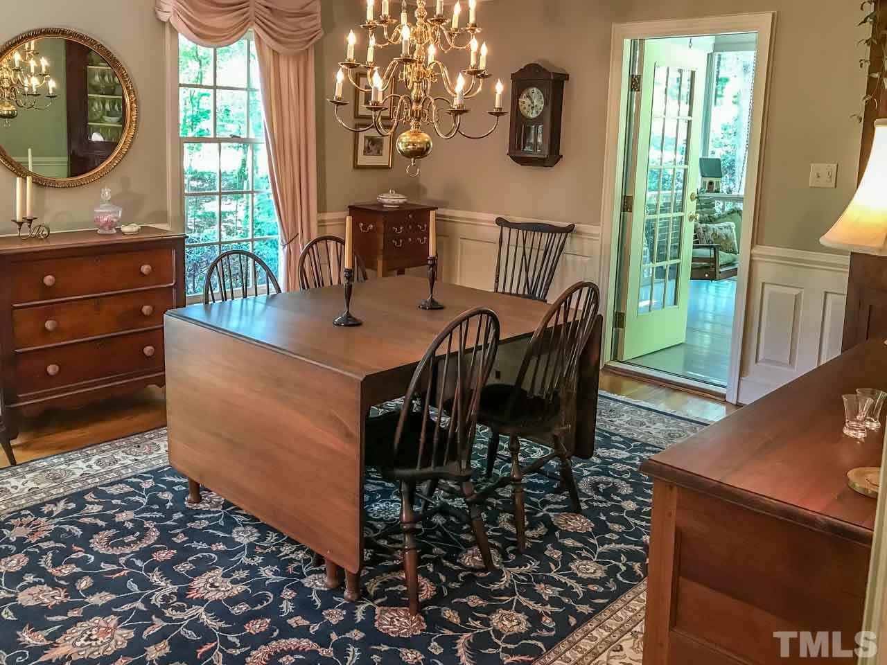 1806 Grande Oaks Road Durham, NC 27712 - Photo 11 of 25 a view of a dining room with furniture and chandelier