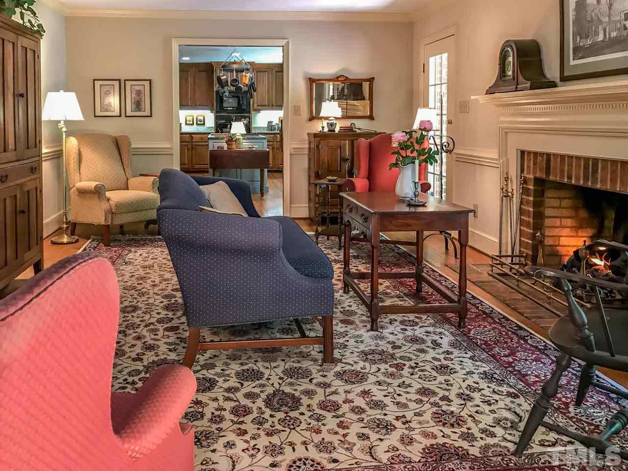 1806 Grande Oaks Road Durham, NC 27712 - Photo 18 of 25 a living room with furniture and a fireplace