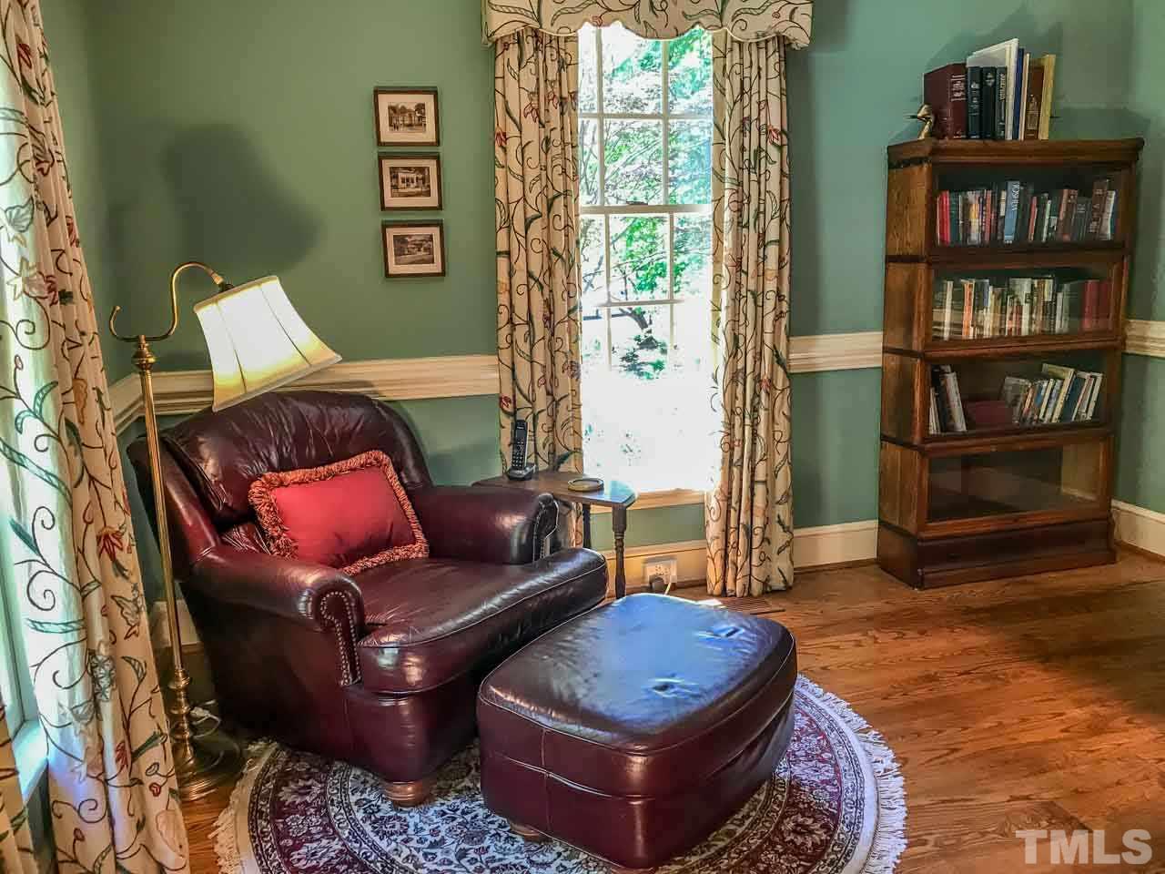 1806 Grande Oaks Road Durham, NC 27712 - Photo 19 of 25 a living room with furniture and a book shelf