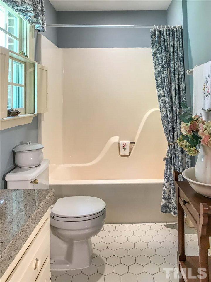1806 Grande Oaks Road Durham, NC 27712 - Photo 20 of 25 a bathroom with a toilet and a bathtub