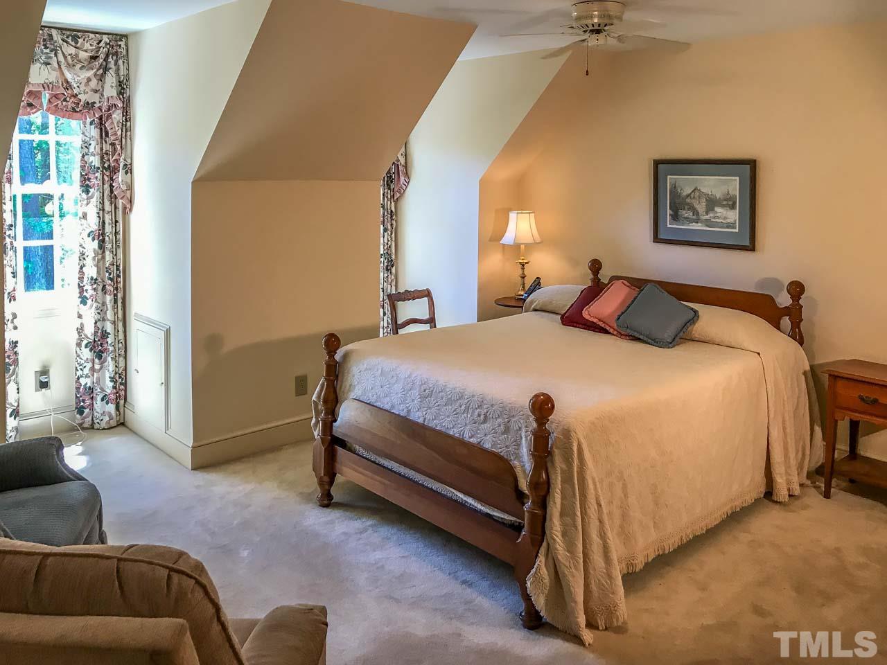 1806 Grande Oaks Road Durham, NC 27712 - Photo 21 of 25 a bedroom with a bed and a couch